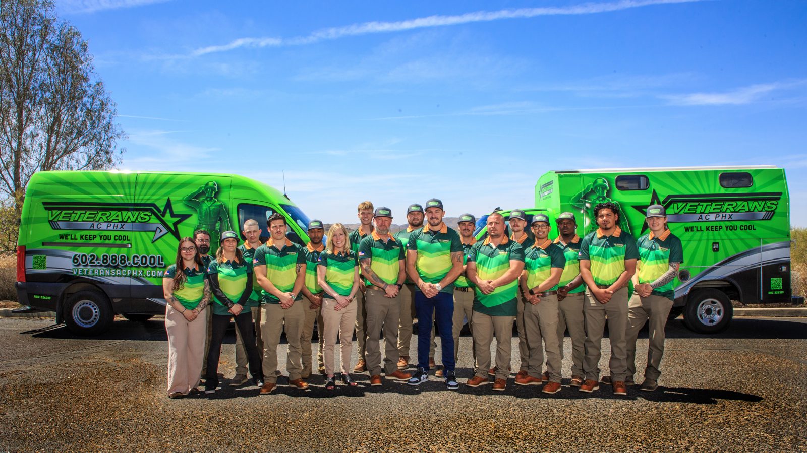The Veterans AC PHX crew in front of their green service vans